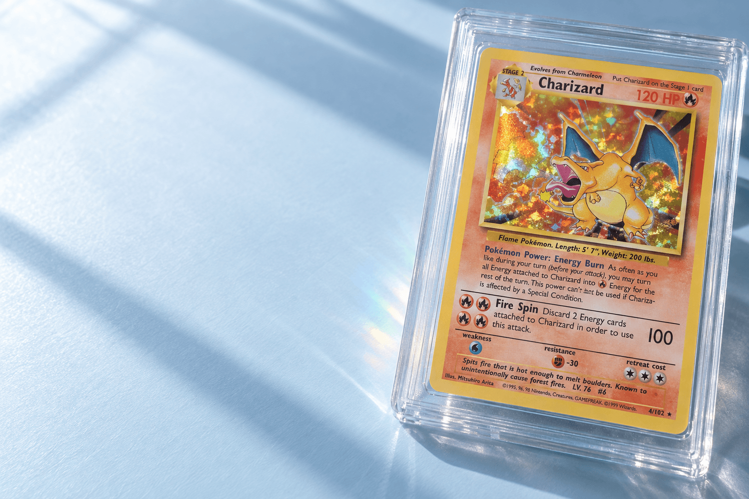 Charizard collectible in a protective slab on a sunlit collector desk